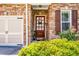 Beautiful front door and entryway with stone facade, manicured shrubs, and flower bed at 1024 Brownstone Dr # 2, Marietta, GA 30008