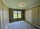 Neutral bedroom with paneled walls and a view of the outdoors at 25 Gladstone Sw Dr, Marietta, GA 30060