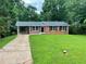 Charming brick home with well-maintained lawn and a covered carport at 25 Gladstone Sw Dr, Marietta, GA 30060