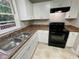 Functional kitchen featuring stainless steel sink and black oven at 25 Gladstone Sw Dr, Marietta, GA 30060