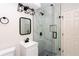 Bathroom featuring frameless glass shower, modern fixtures, and black accents at 504 Milligan Dr, Stone Mountain, GA 30083