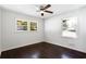 Bright bedroom features hardwood floors, modern ceiling fan, and double windows overlooking a lush landscape at 504 Milligan Dr, Stone Mountain, GA 30083