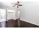 Spacious bedroom with hardwood floors, ceiling fan, and an ensuite bathroom with tiled shower at 504 Milligan Dr, Stone Mountain, GA 30083