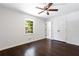 Spacious bedroom with hardwood floors, ceiling fan, and a large closet for storage at 504 Milligan Dr, Stone Mountain, GA 30083