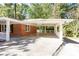 Brick home featuring a spacious carport with white columns and railing, offering convenient covered parking and charming curb appeal at 504 Milligan Dr, Stone Mountain, GA 30083