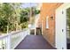 Back deck with white railing overlooking yard and brick home exterior at 504 Milligan Dr, Stone Mountain, GA 30083