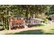 Attractive brick home with well-maintained lawn, covered carport, and inviting front porch, exuding charm and curb appeal at 504 Milligan Dr, Stone Mountain, GA 30083
