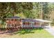 Charming brick home with a covered front porch and carport, nestled among mature trees at 504 Milligan Dr, Stone Mountain, GA 30083