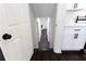 Hallway leads to kitchen with white cabinets, granite countertops and black hardware accents at 504 Milligan Dr, Stone Mountain, GA 30083