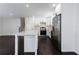Well-lit kitchen featuring stainless steel appliances and a kitchen island at 504 Milligan Dr, Stone Mountain, GA 30083