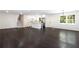 Open concept kitchen and living room, featuring new hardwood floors and white walls at 504 Milligan Dr, Stone Mountain, GA 30083