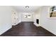 Open living room with brick fireplace, dark floors and windows offering plenty of natural light at 504 Milligan Dr, Stone Mountain, GA 30083