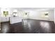 Spacious living room featuring hardwood floors, white walls, and abundant natural light at 504 Milligan Dr, Stone Mountain, GA 30083