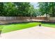 Lush backyard featuring a patio and a tall fence with greenery at 2373 Oak Falls Ln, Buford, GA 30519