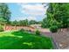 Well-maintained backyard with grass and fence offers privacy and landscaping potential at 2373 Oak Falls Ln, Buford, GA 30519