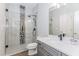 Updated bathroom featuring glass enclosed shower with a mosaic tile accent wall and gray vanity at 2373 Oak Falls Ln, Buford, GA 30519