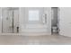 Bright bathroom featuring a soaking tub, step-in shower, and a separate water closet at 2373 Oak Falls Ln, Buford, GA 30519