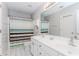 Bright bathroom featuring a double vanity, large mirror, and tiled floor at 2373 Oak Falls Ln, Buford, GA 30519