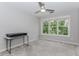 Bright bedroom with large windows and neutral carpet features modern ceiling fan and workspace at 2373 Oak Falls Ln, Buford, GA 30519