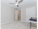 Cozy bedroom with light gray walls and carpeting shows a ceiling fan and an open door at 2373 Oak Falls Ln, Buford, GA 30519