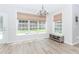 Sunny dining area with large windows, chandelier, and wood-style floors at 2373 Oak Falls Ln, Buford, GA 30519