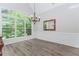Bright dining room with large windows, stylish chandelier, and detailed wall molding at 2373 Oak Falls Ln, Buford, GA 30519