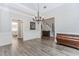 Open dining room boasts wood floors, elegant lighting, and classic architectural details at 2373 Oak Falls Ln, Buford, GA 30519