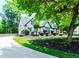Charming home showcasing meticulous landscaping and an inviting driveway, nestled amidst lush greenery at 2373 Oak Falls Ln, Buford, GA 30519