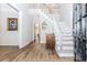 Bright and airy foyer with hardwood flooring, featuring a staircase and elegant decor at 2373 Oak Falls Ln, Buford, GA 30519