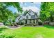 Beautifully landscaped front yard featuring lush green grass and manicured bushes, enhancing curb appeal at 2373 Oak Falls Ln, Buford, GA 30519