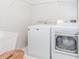 Convenient laundry room with washer, dryer, utility sink, and overhead shelving at 2373 Oak Falls Ln, Buford, GA 30519