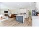 Open-concept living room with fireplace, wood-style floors, and view of the kitchen at 2373 Oak Falls Ln, Buford, GA 30519
