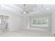 A light-filled main bedroom features a trey ceiling, a ceiling fan, and en-suite bath at 2373 Oak Falls Ln, Buford, GA 30519