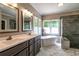 Modern bathroom with double sinks, soaking tub, and a glass-enclosed shower at 349 Harris Loop, Dallas, GA 30157