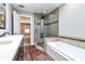 Bathroom featuring tiled shower, soaking tub with tile surround, and double sink vanity at 349 Harris Loop, Dallas, GA 30157