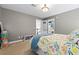 Bedroom showing neutral walls, closet, carpet floor, and bed with floral-patterned bedding and blue blanket at 4004 Charrwood Trce, Marietta, GA 30062