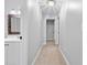Hallway with carpet floor, a view into a bathroom, and a wall sconce at 4004 Charrwood Trce, Marietta, GA 30062