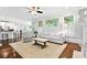 Bright living room with hardwood floors, large windows, and comfortable furniture at 4004 Charrwood Trce, Marietta, GA 30062