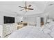 Bright main bedroom features a ceiling fan, television, fireplace, and ensuite bathroom at 4004 Charrwood Trce, Marietta, GA 30062