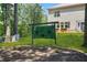 Picturesque backyard with mature trees, a large lawn, and a green decorative screen at 625 St Annes Pl, Covington, GA 30016