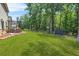 Expansive backyard featuring lush greenery, an outdoor patio and additional seating areas at 625 St Annes Pl, Covington, GA 30016