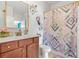 Charming bathroom with a decorative shower curtain, vanity, and wall art at 625 St Annes Pl, Covington, GA 30016