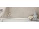 A close-up of a soaking bathtub with decorative elements at 625 St Annes Pl, Covington, GA 30016