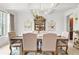Bright dining room features a modern light fixture and elegant display cabinet at 625 St Annes Pl, Covington, GA 30016