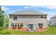 Spacious home exterior features a well-manicured lawn, tasteful landscaping, and outdoor patio at 625 St Annes Pl, Covington, GA 30016