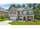 Inviting two-story home boasting a blend of brick, stone, and siding with a manicured front yard at 625 St Annes Pl, Covington, GA 30016