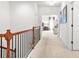 Bright hallway with wood and black iron railing leading to the bedrooms at 625 St Annes Pl, Covington, GA 30016
