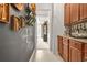 Hallway features gray walls with decorative wine art, built in cabinet and dining room view at 625 St Annes Pl, Covington, GA 30016