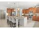 Kitchen island features granite countertop, seating, stainless appliances, and pendant lighting at 625 St Annes Pl, Covington, GA 30016