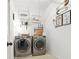 Cozy laundry room with side by side washer and dryer and decor at 625 St Annes Pl, Covington, GA 30016